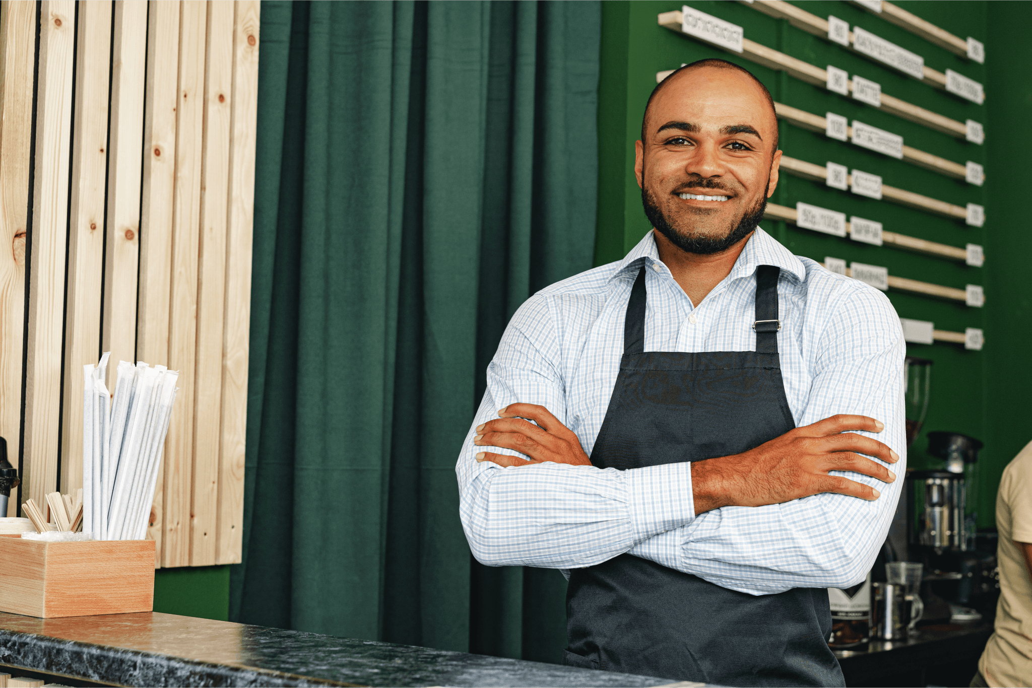 Small business owner standing in the doorway of their shop